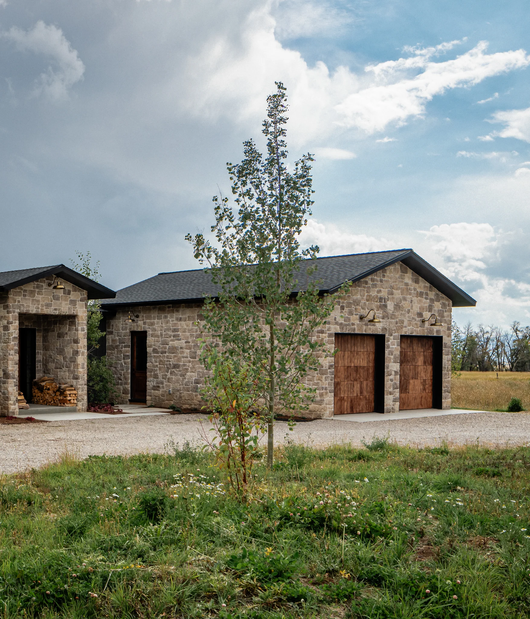 Detached stone garage and outbuilding with wood doors — architectural photography Driggs Idaho, WTG Architects